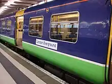 An old unit in purple and green Silverlink livery with a London Overground sticker